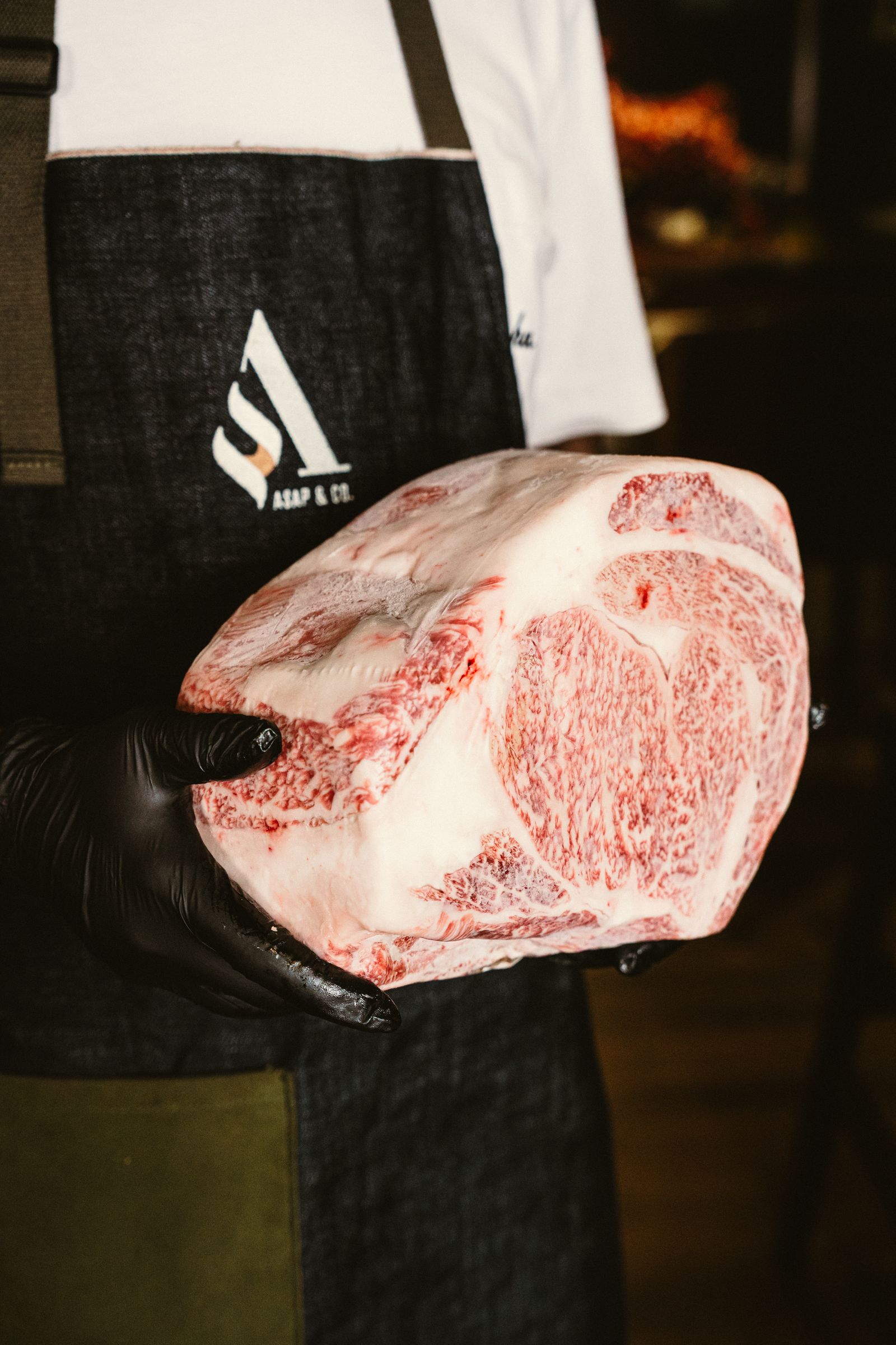 A raw, heavily marbled Wagyu primal in the kitchen