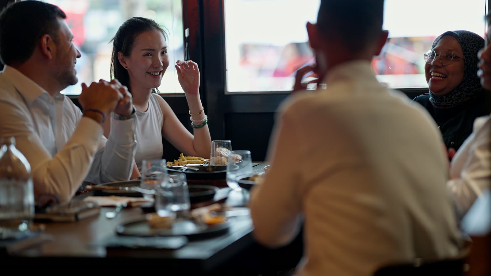 Guests sharing a long table over dinner